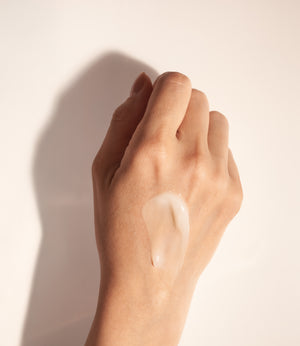 Back of hand showing lightweight anti aging skincare serum texture